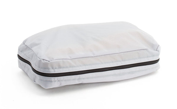 A filled and zipped closed Northwest Sky (light grey) Aether End Pocket Aeronaut 30 Packing Cube.